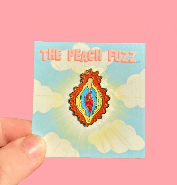 Colorful "Vulva Mary" enamel pin by The Peach Fuzz on cloud card with radiant aura design
