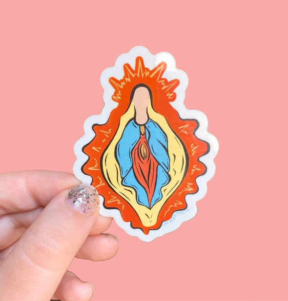 Model's hand holds a sticker with colorful, stylized design of vulvar anatomy