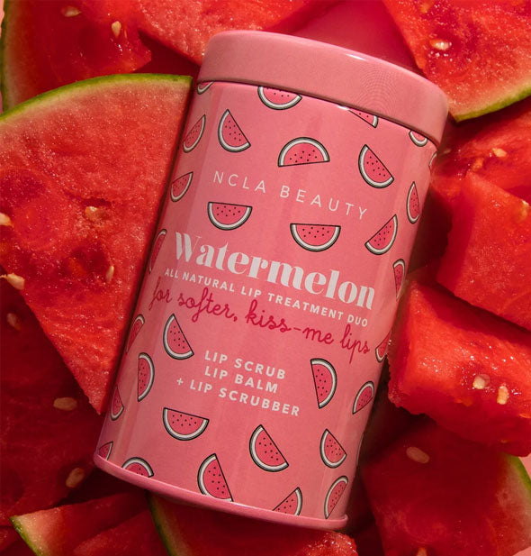 NCLA Beauty Watermelon All Natural Lip Treatment Duo tin rests on slices of fresh watermelon