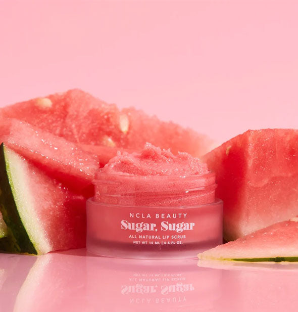 Pot of pink NCLA Beauty Sugar, Sugar All Natural Lip Scrub flanked by pieces of watermelon