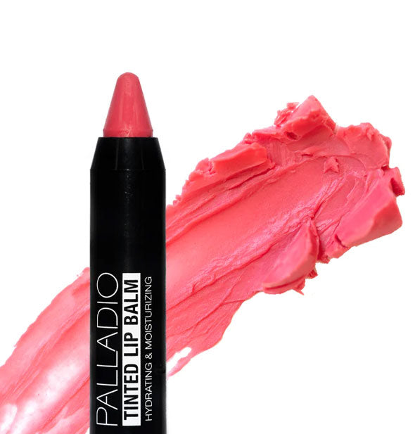 Stick of Palladio Tinted Lip Balm with pointed tip and sample application behind in the shade Watermelon Sugar