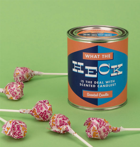 What the Heck Is the Deal With Scented Candles? Scented Candle is staged with Dum Dums on a green background