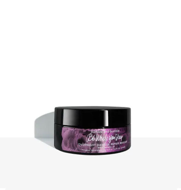 Purple and black 6.4 ounce tub of Bumble and bumble While You Sleep Overnight Damage Repair Masque