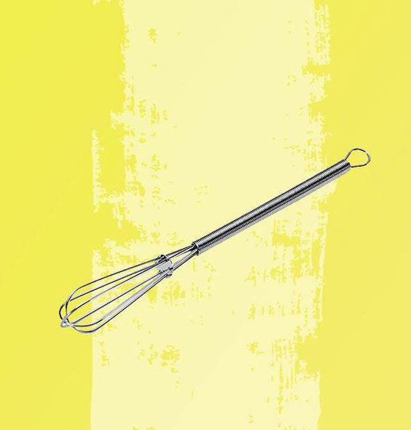 Stainless steel hair color whisk on yellow bckground