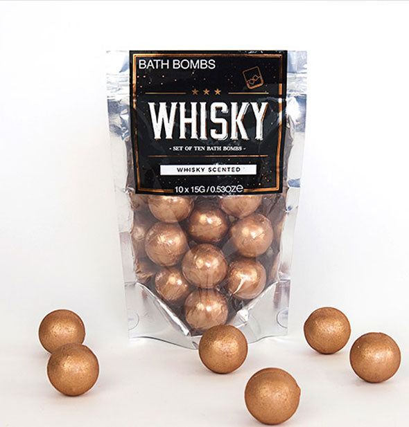 Metallic bag of pearlescent copper-colored Whisky Bath Bombs with several removed and placed in the foreground