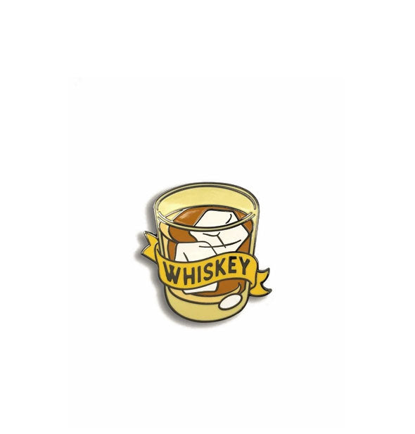 Enamel pin in the shape of a rocks glass with ice cubes wrapped in a banner that says, "Whiskey"