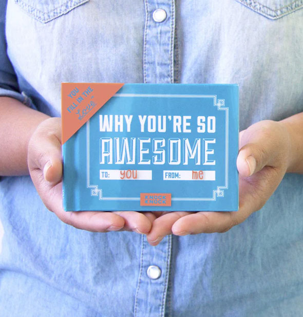 Model holds a copy of Why You're So Awesome for size reference