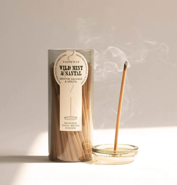 Lid removed from a glass tube of Paddywax Wild Mint & Santal incense sticks doubles as a holder for one burning stick