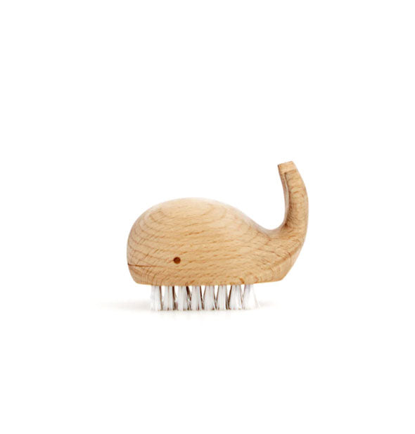 Wooden whale-shaped brush with short, white bristles