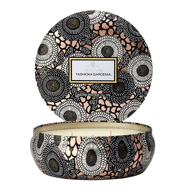Round black, white, and peach floral Yashioka Gardenia Voluspa tin candle with lid removed