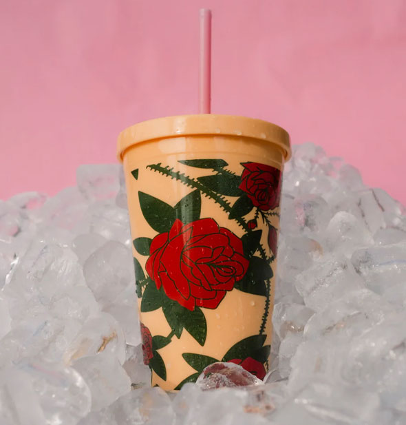 Yellow thorny rose drink tumbler on ice against a pink background