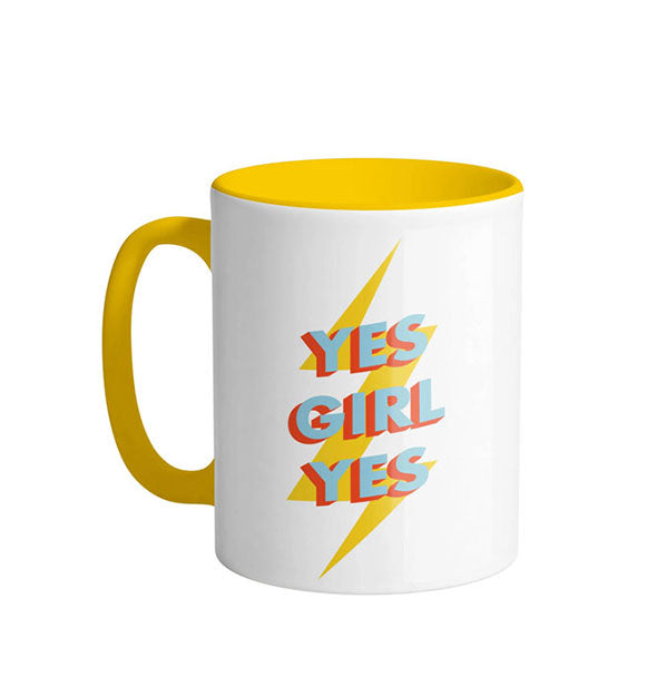 White coffee mug with yellow interior, yellow handle, and yellow lightning bolt graphic says, "Yes Girl  Yes" in blue and red lettering