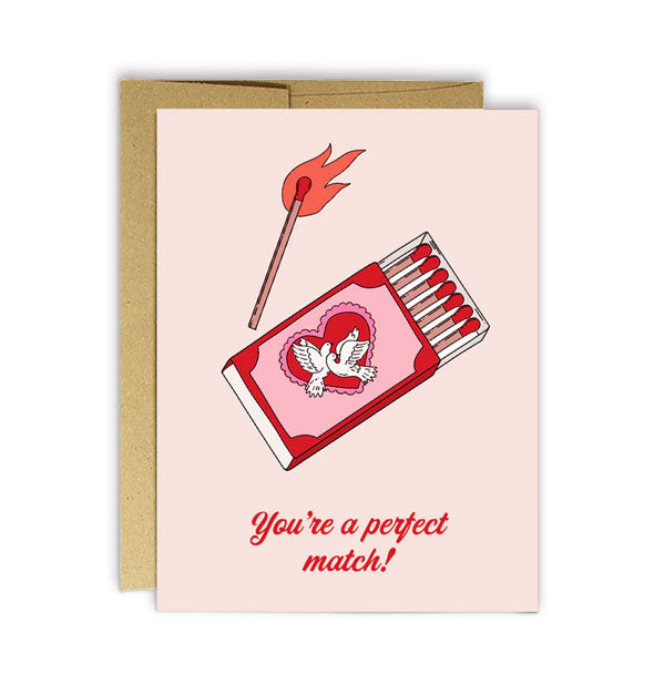 Light pink greeting card with kraft envelope features illustration of an opened matchbox with doves and heart design beneath a lit match and the words, "You're a perfect match!" underneath in red script