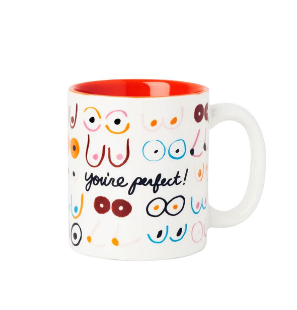 White coffee mug with red interior features all-over colorful illustrations of breast pairs and says, "You're perfect!" in black cursive