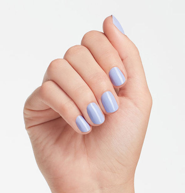 Model's hand wears a periwinkle shade of nail polish