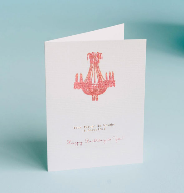 Greeting card featuring monochromatic chandelier illustration is captioned, "Your future is bright & beautiful. Happy birthday to you!"